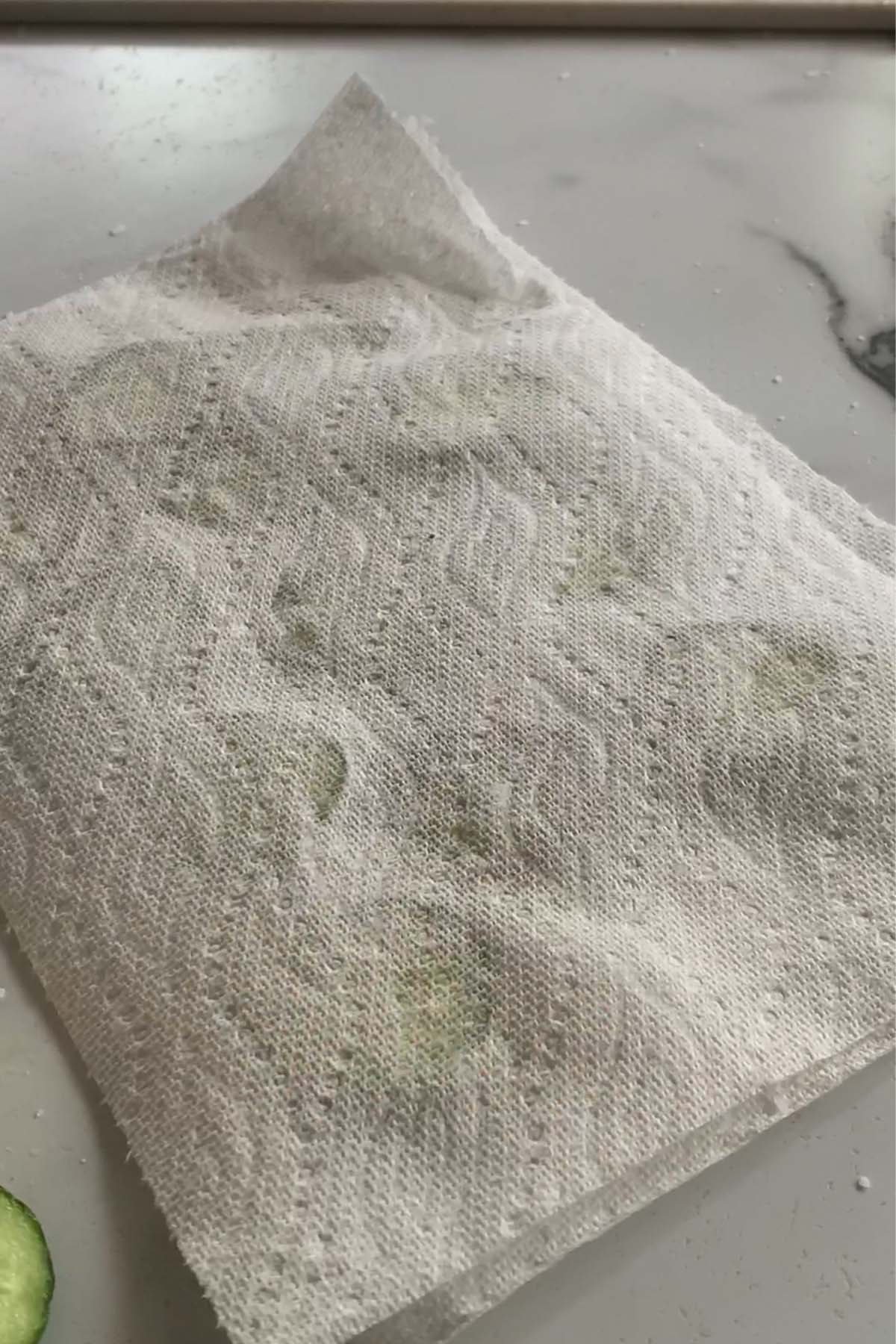 Drawing moisture out of the cucumber with salt and paper towel.