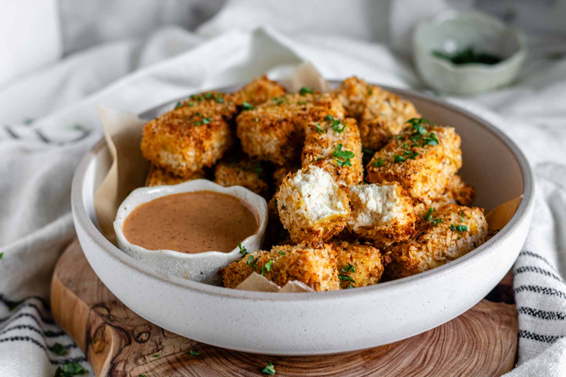 Tofu nuggets in a bowl with a sauce.