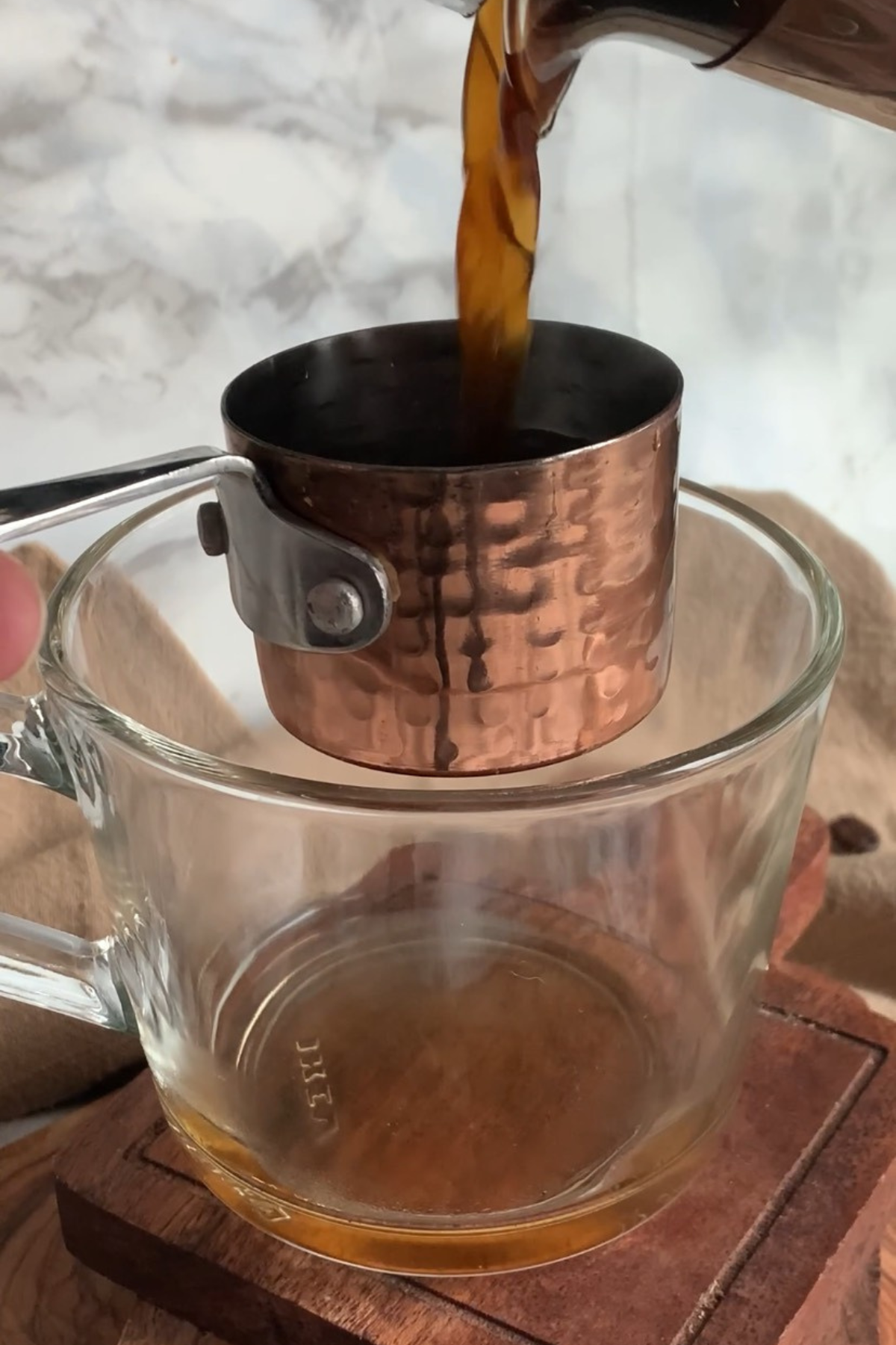 Adding coffee to a mug.
