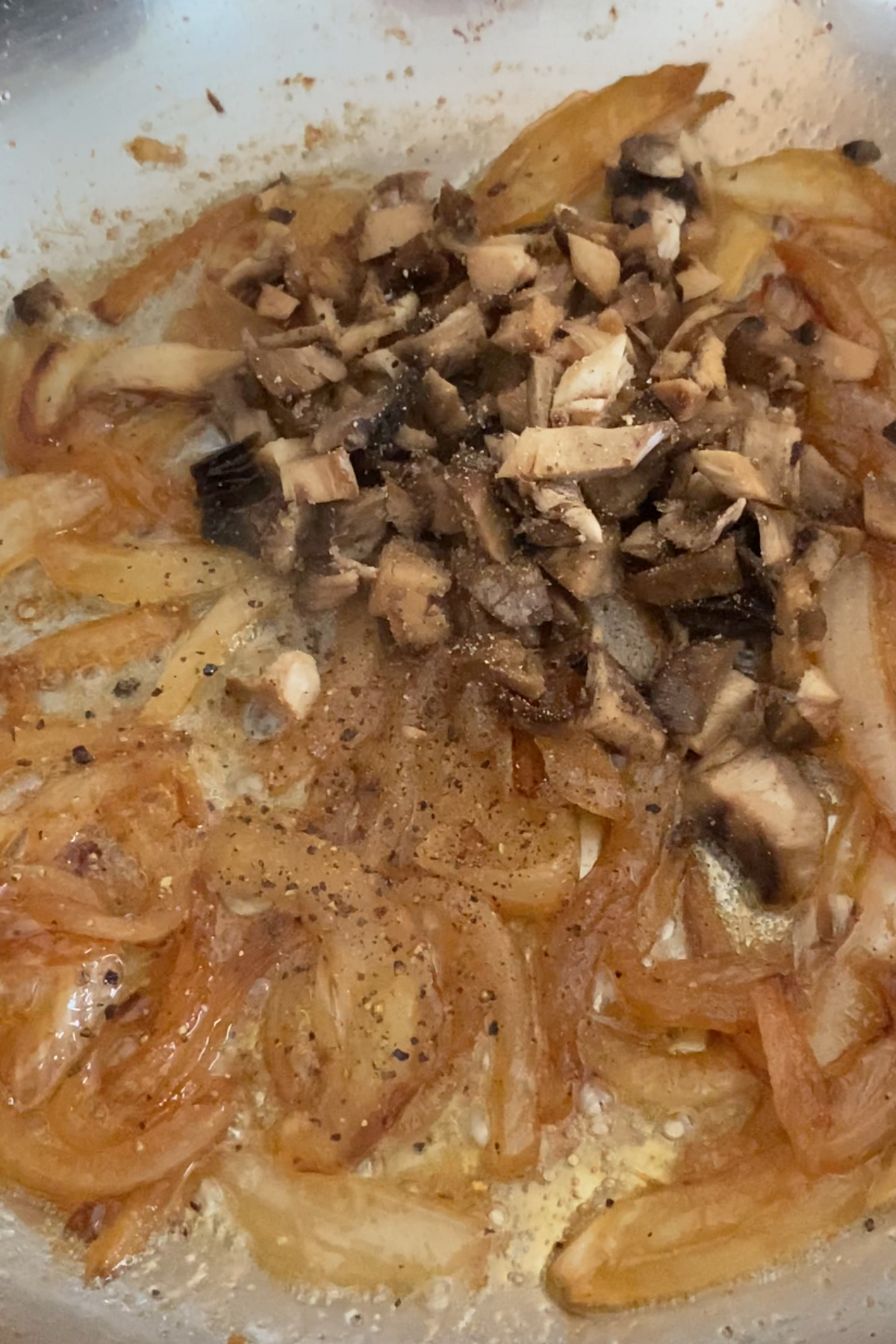 Adding mushrooms to the onion.