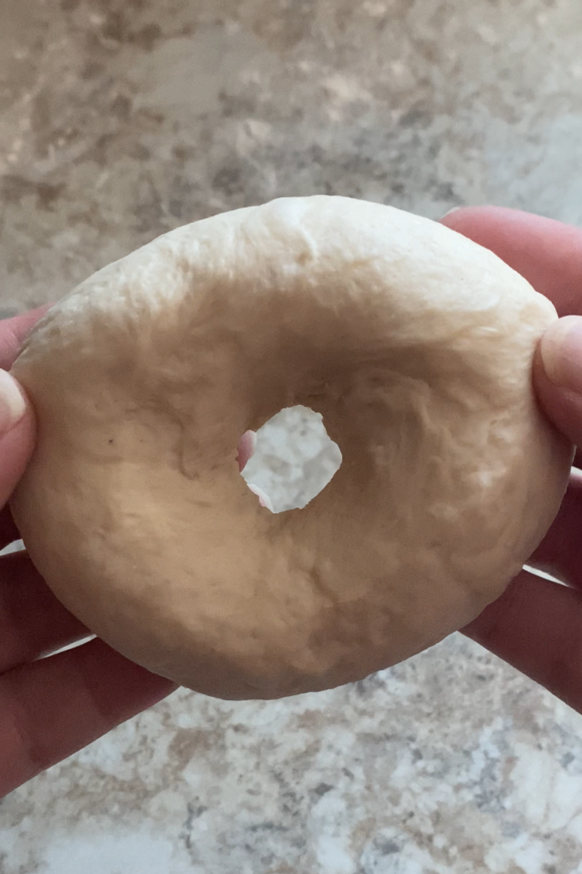 Shaping the dough into a bagel shape.