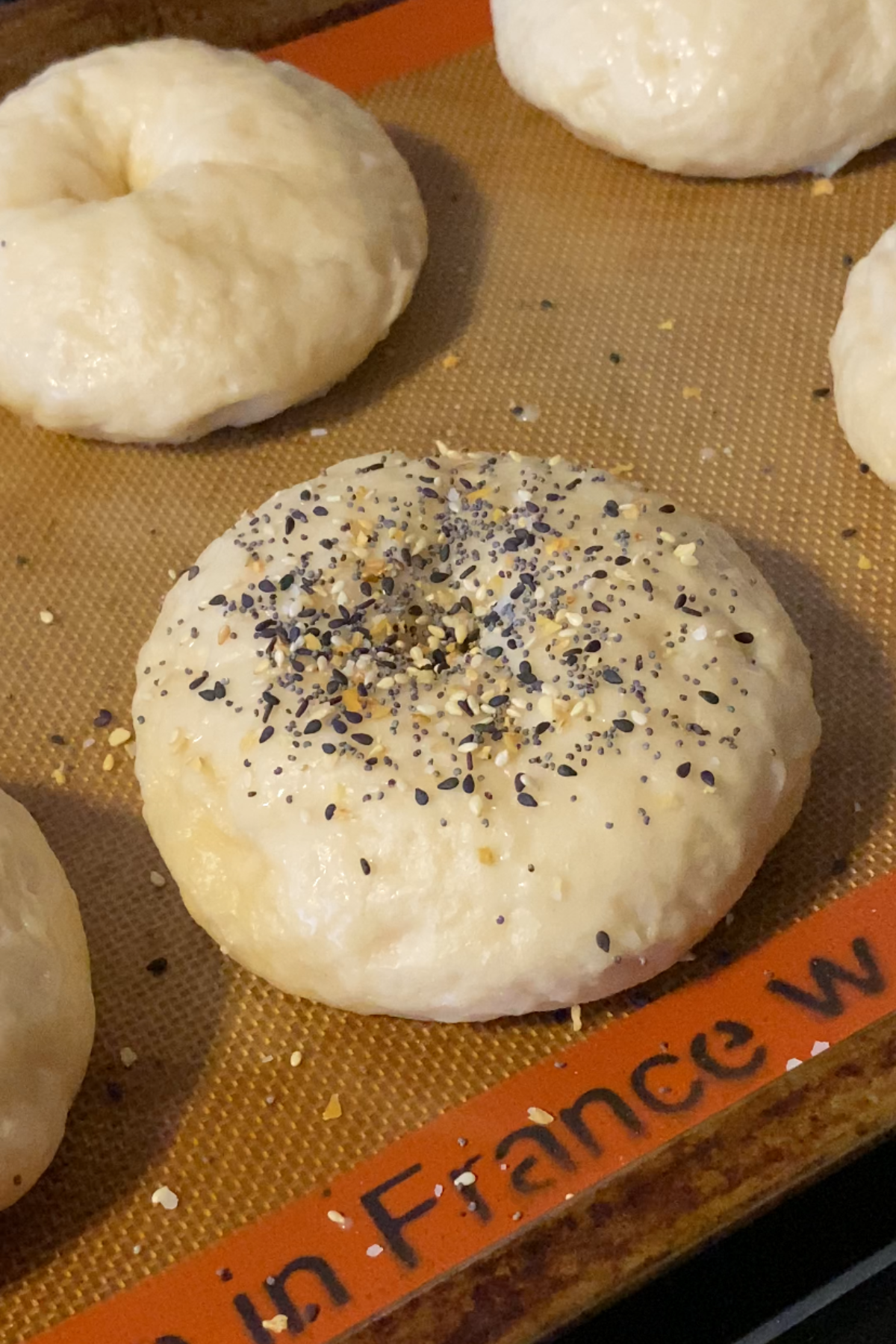 Decorating bagels with toppings.
