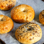 Vegan bagels on a baking sheet.