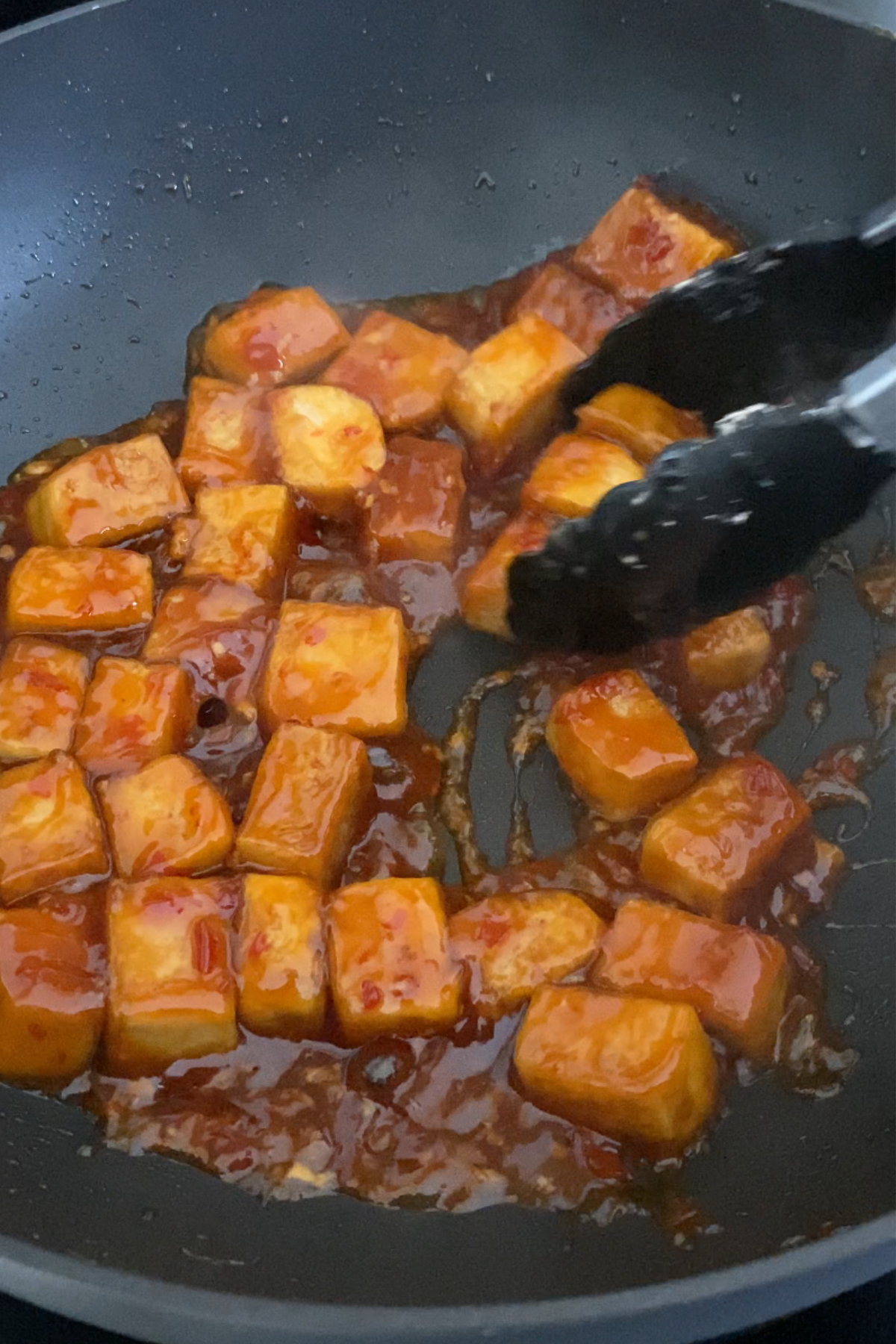Cooking tofu and sweet chili sauce.