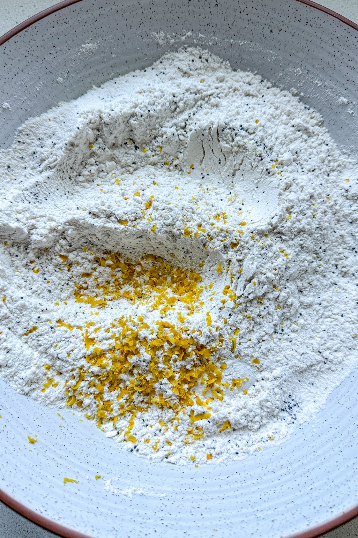 Lemon poppy seed dry ingredients in a white bowl.