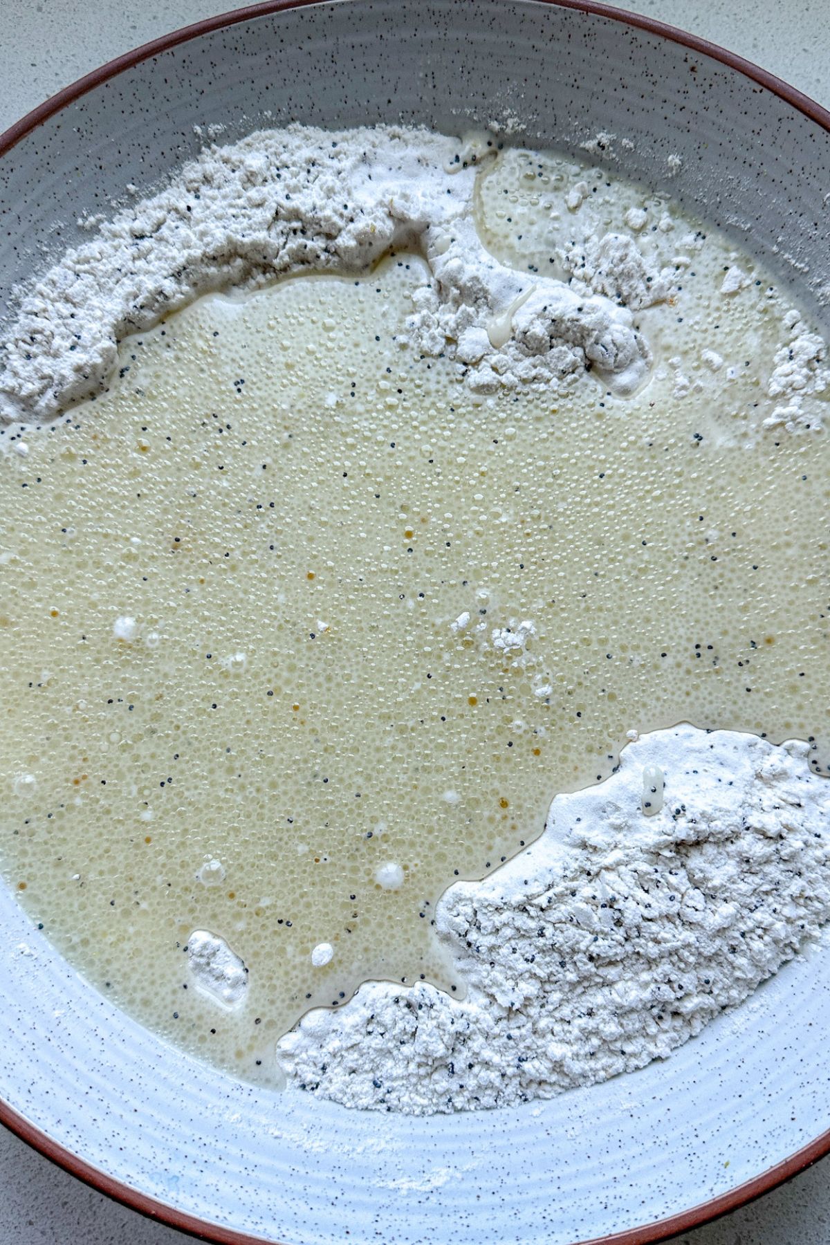 Lemon poppy seed cake ingredients in a white bowl.