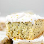 A close up of a square of frosted lemon poppy seed cake.