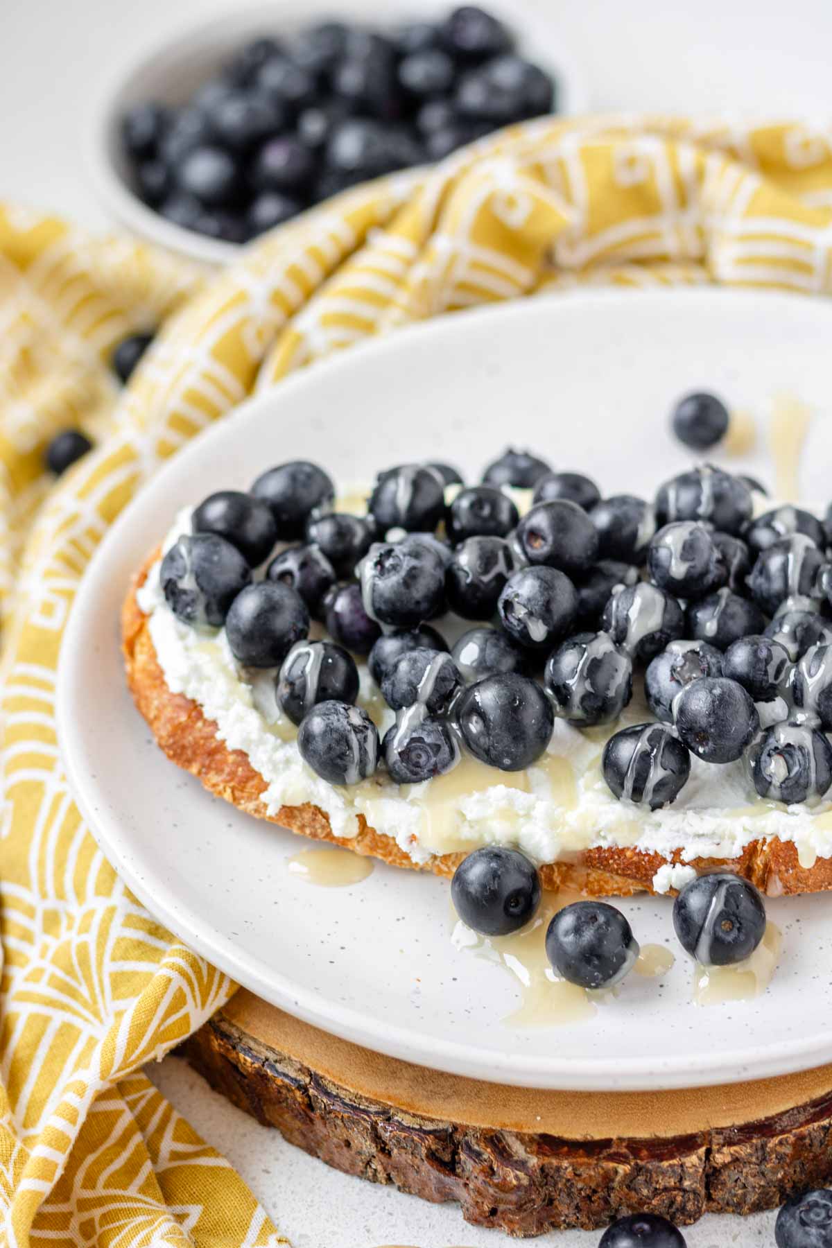 Toast topped with goat cheese, blueberries and honey.
