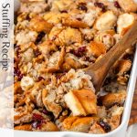 Stuffing with walnuts and cranberries in a white baking dish with black text along the side.