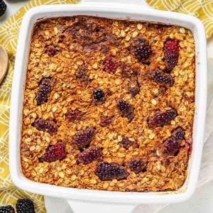 A top down view of baked oatmeal with blackberries scattered through the top.