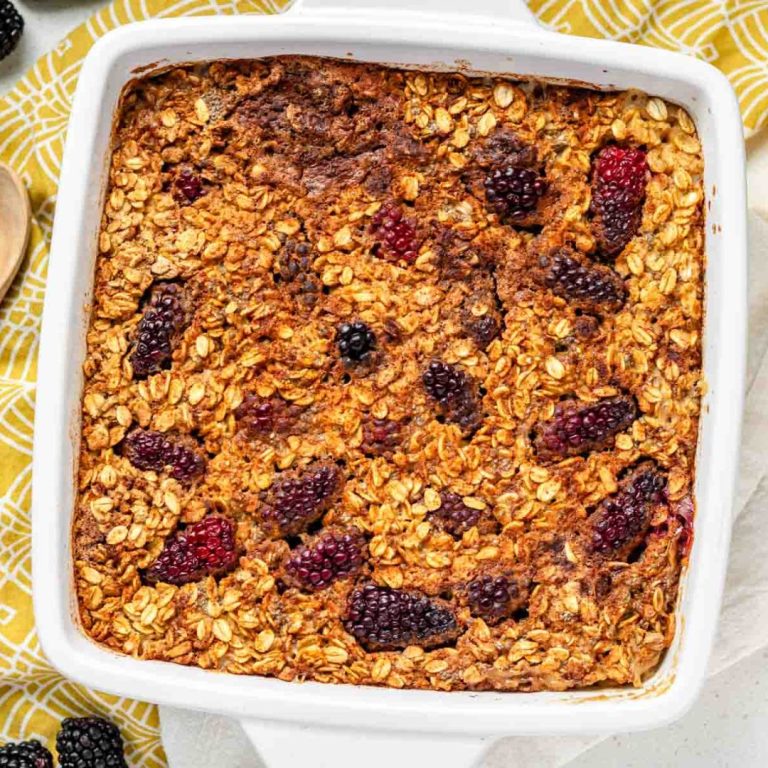 A top down view of baked oatmeal with blackberries scattered through the top.