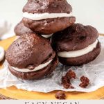 Vegan whoopie pies on a wooden platter with text below.