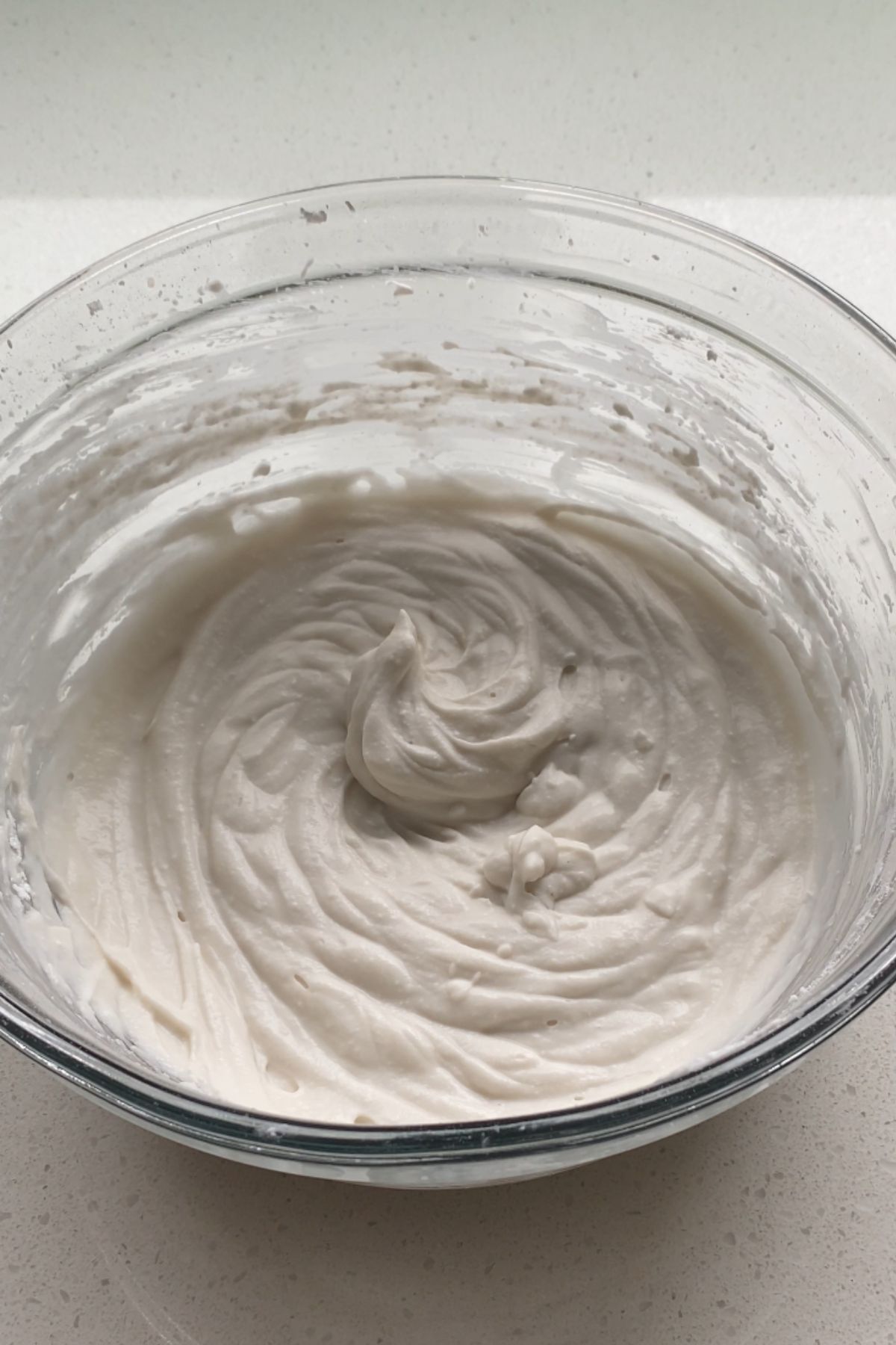 Coconut whipped cream in a glass bowl.