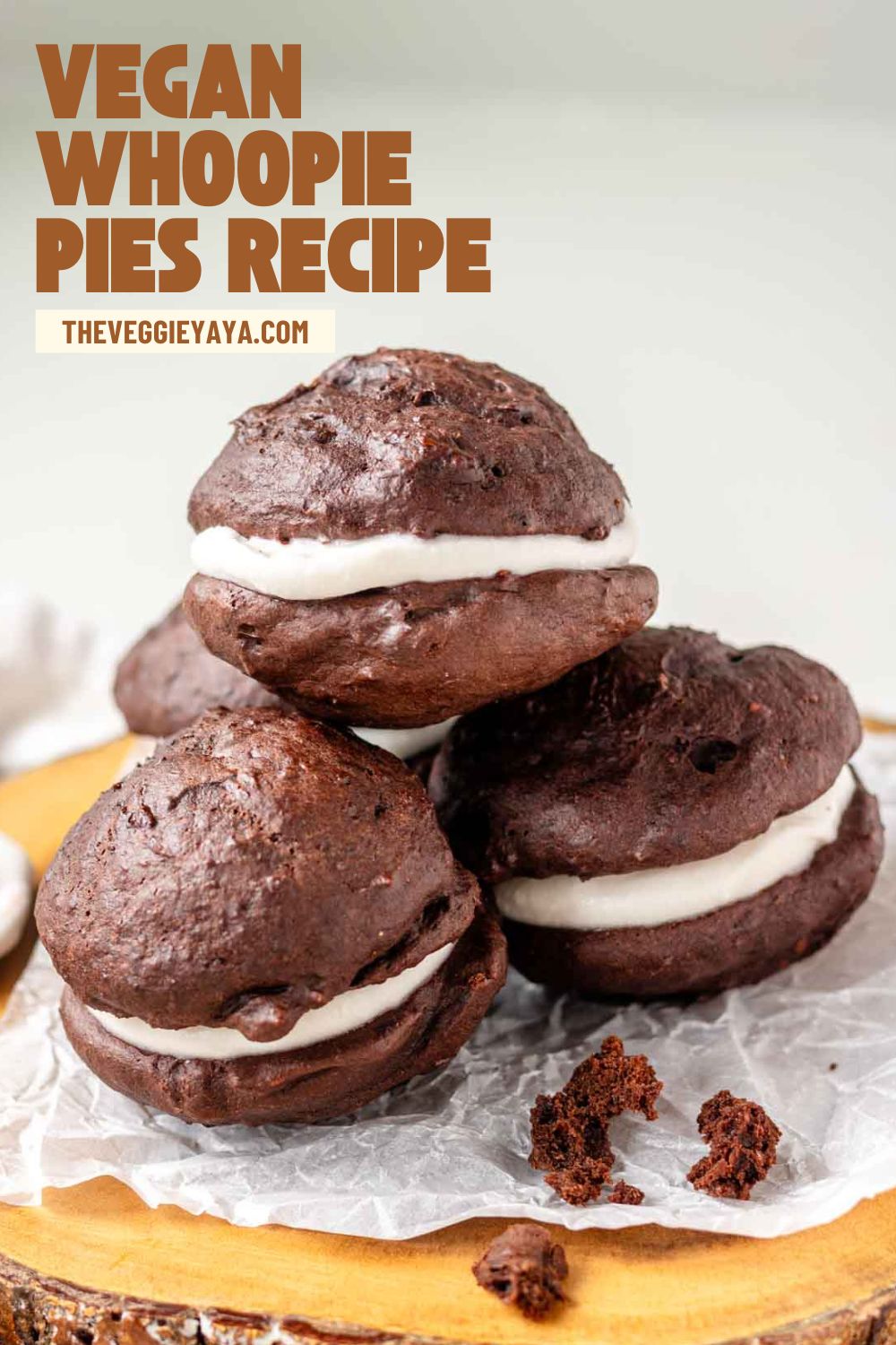 Vegan whoopie pies on a wooden platter with text above.