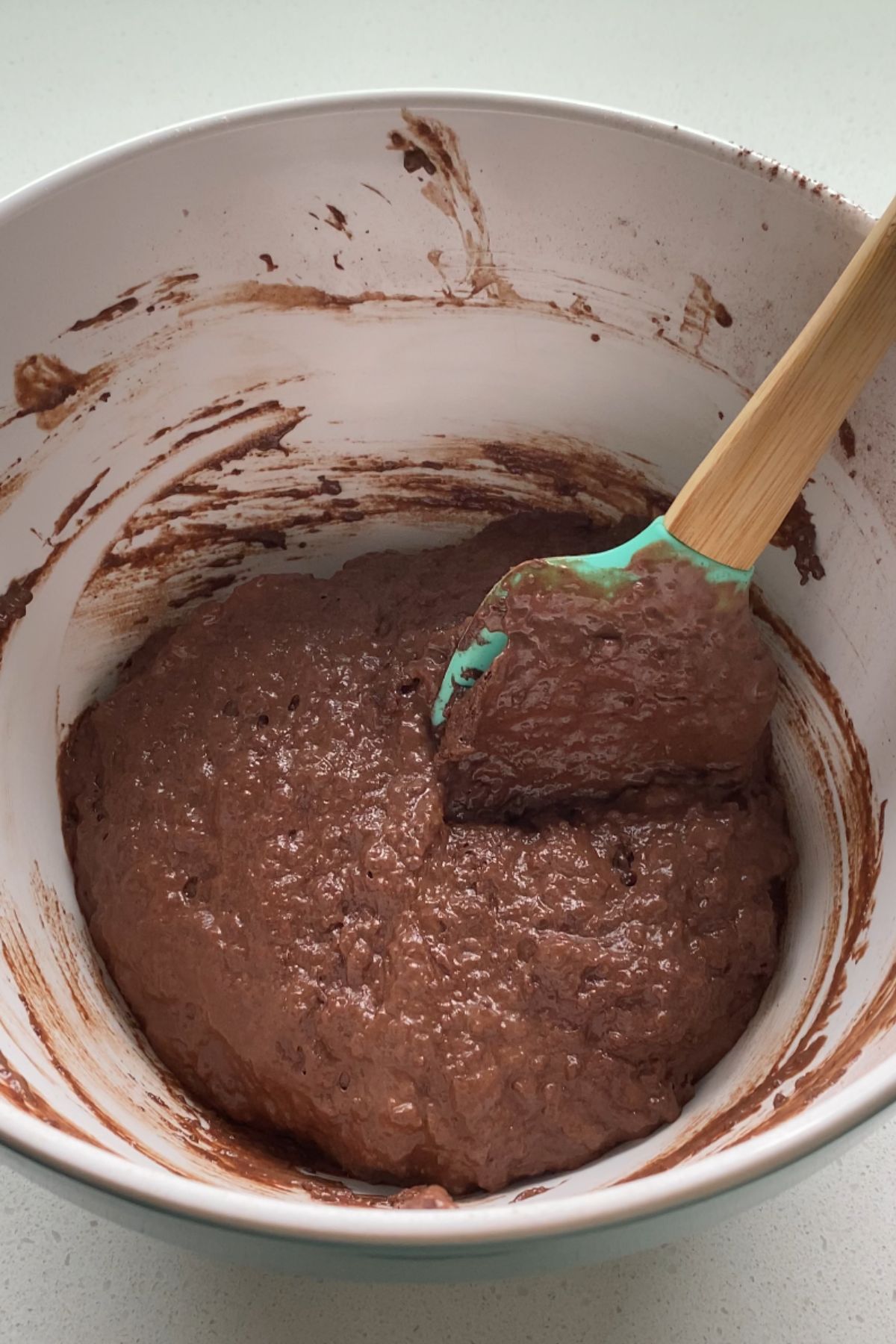 Whoopie pie cake batter in a mixing bowl with a spatula.