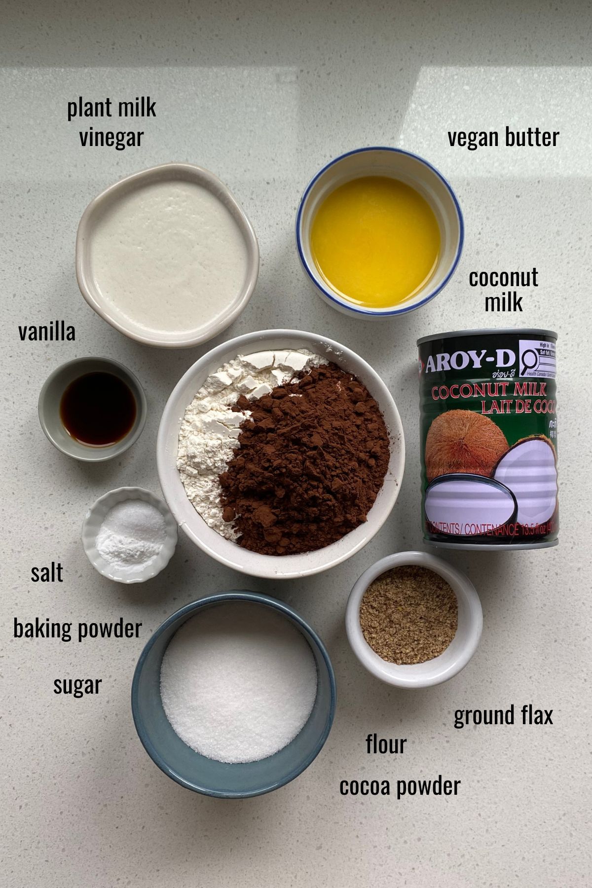 Vegan whoopie pie ingredients in dishes on a white counter top.