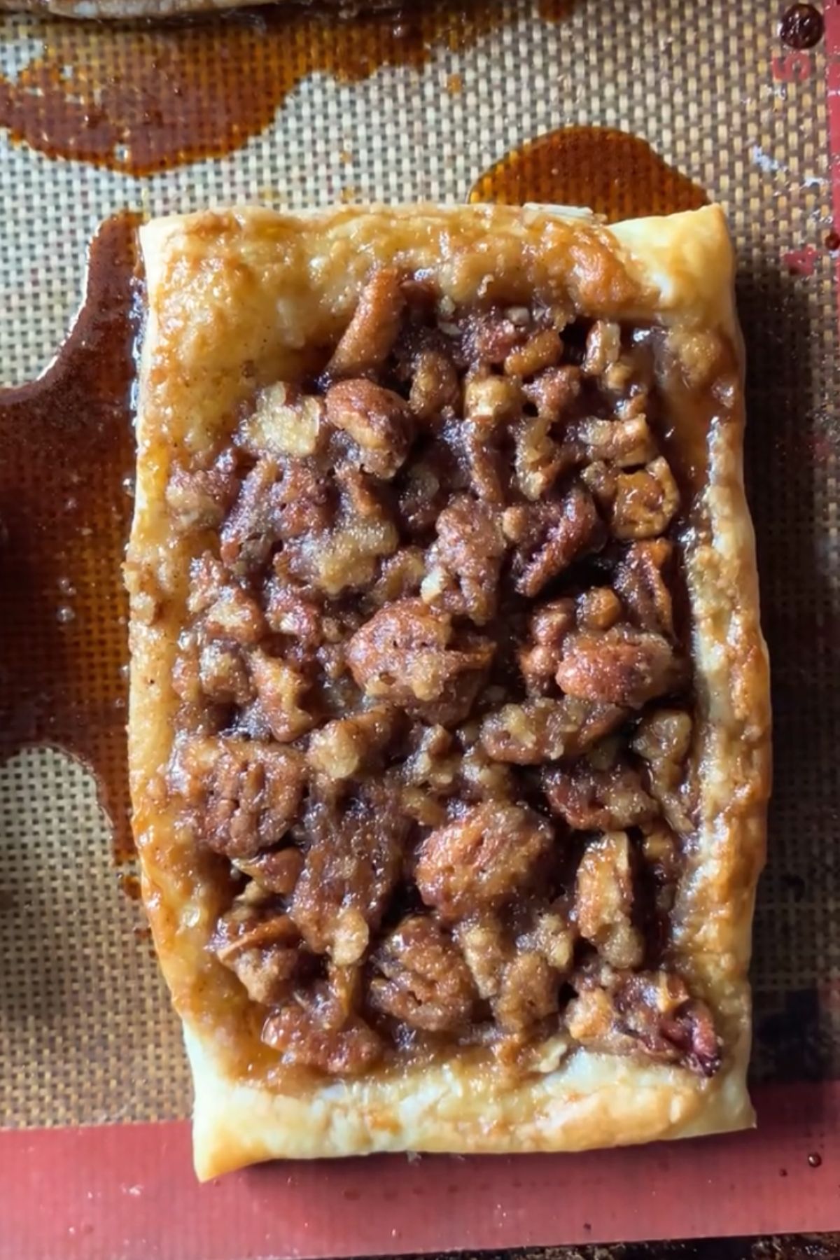 A maple pecan danish on a baking sheet fresh from the oven.