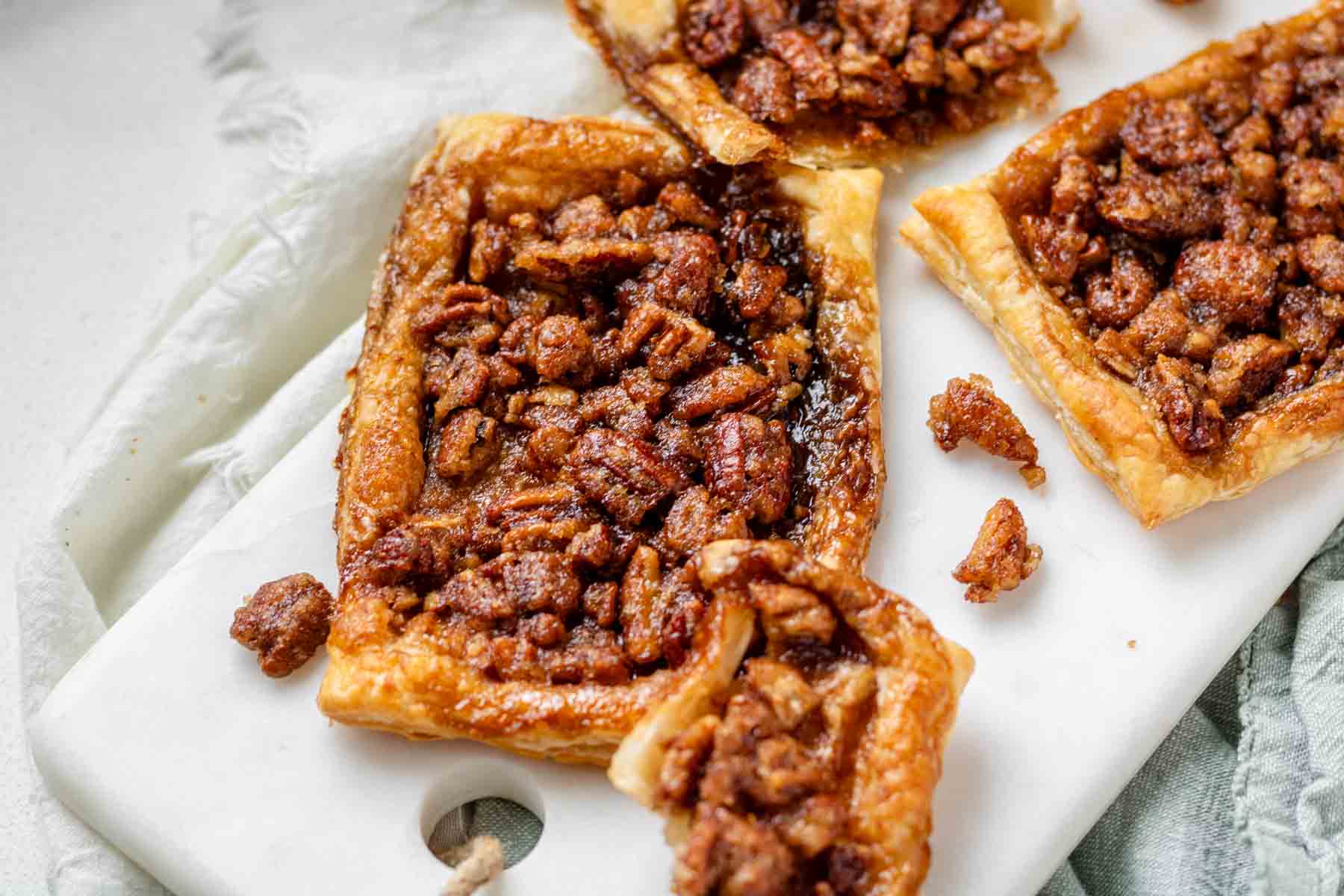 Maple pecan danishes on a white marble serving board.