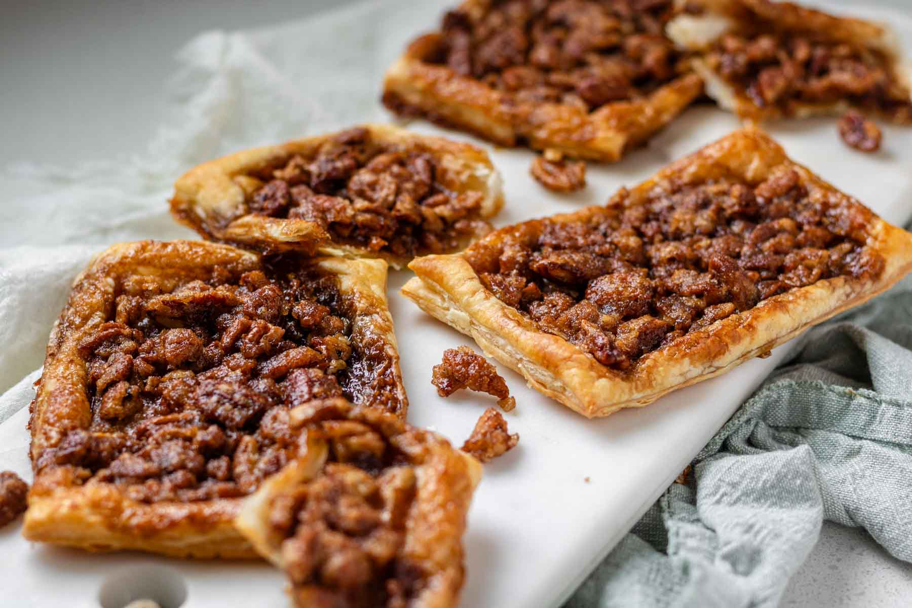 Maple pecan danishes on a white marble serving board.