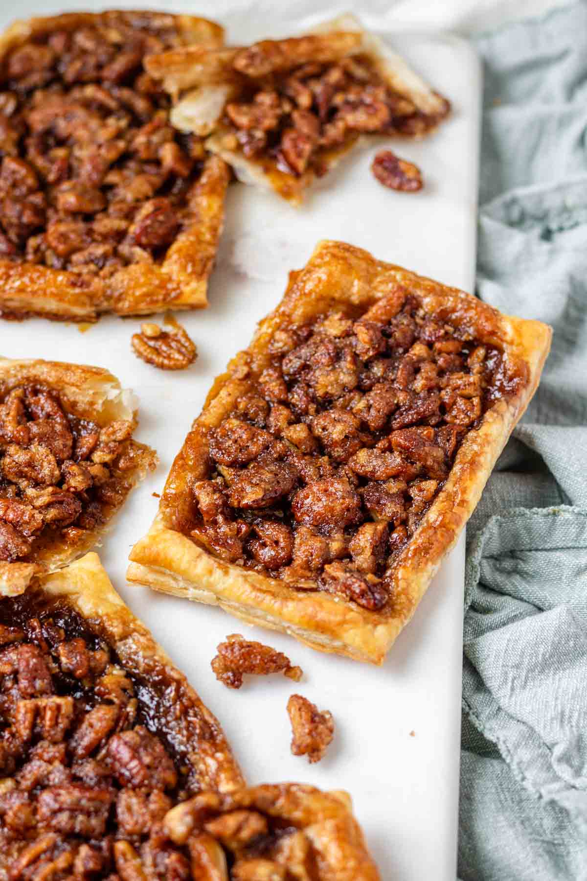 Maple pecan danishes on a white marble serving board.