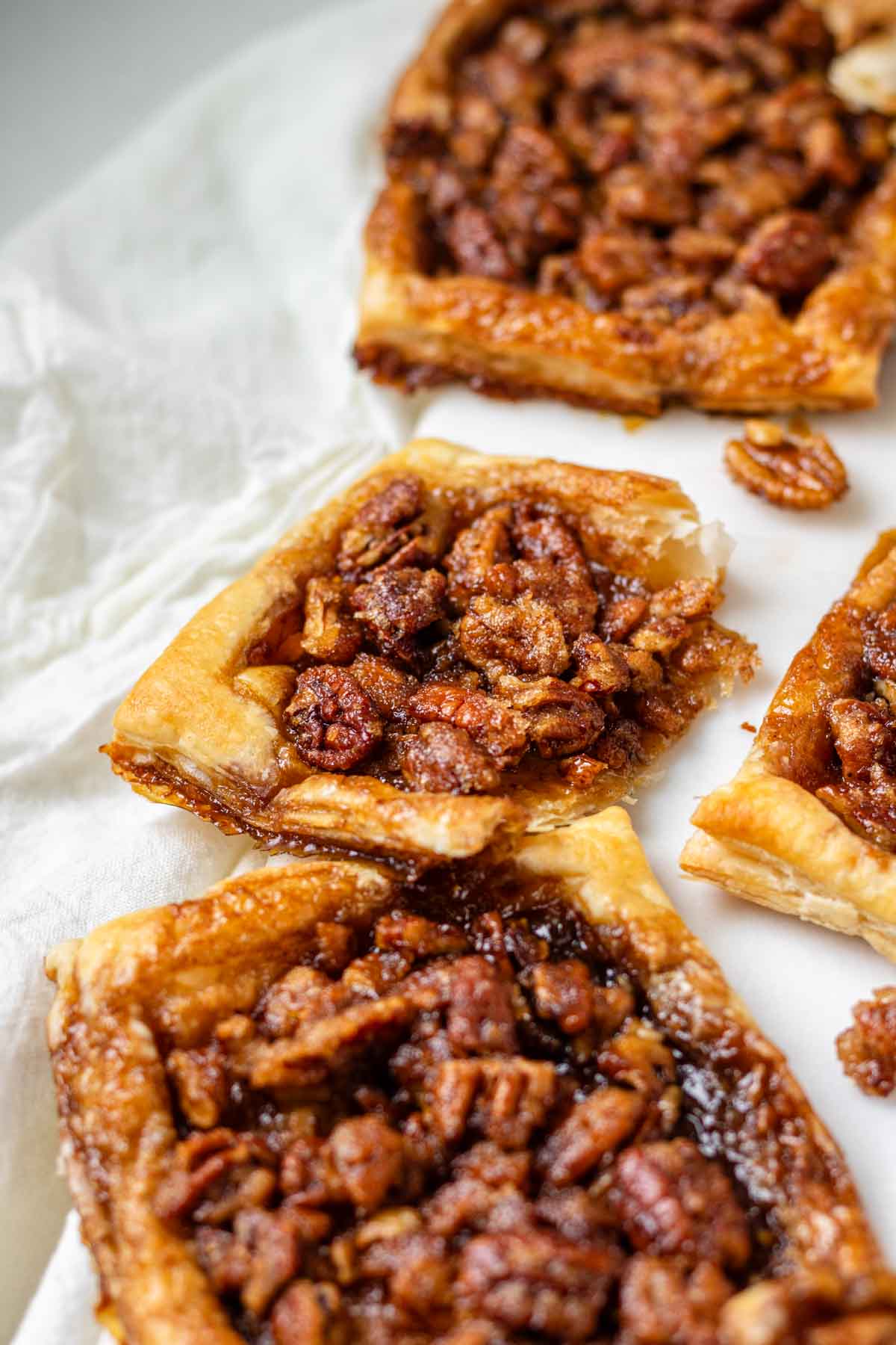 Maple pecan danishes on a white marble serving board.
